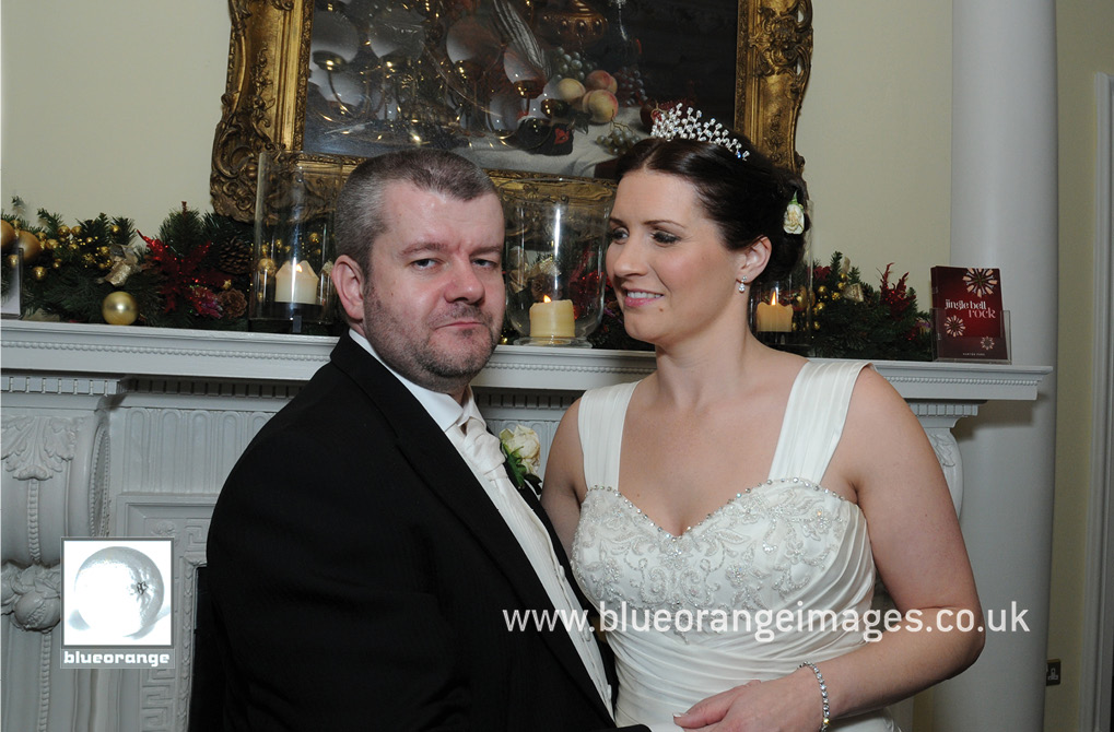 Wedding at Hunton Park venue – bride and groom photo at mantlepiece, evening photos