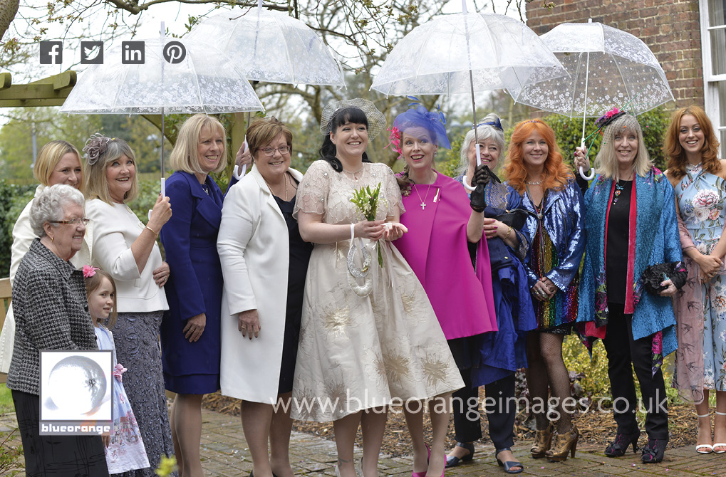 Carrie, the bride and the girls with umbrellas, at her Watford registry office wedding