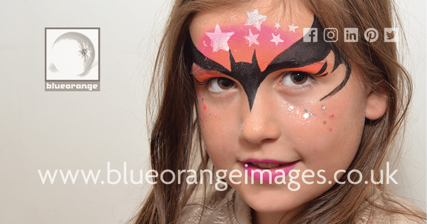 Edna face painting, face glitter & glitter tattoos, Watford. Batman and stars design on brow with glitter on cheeks