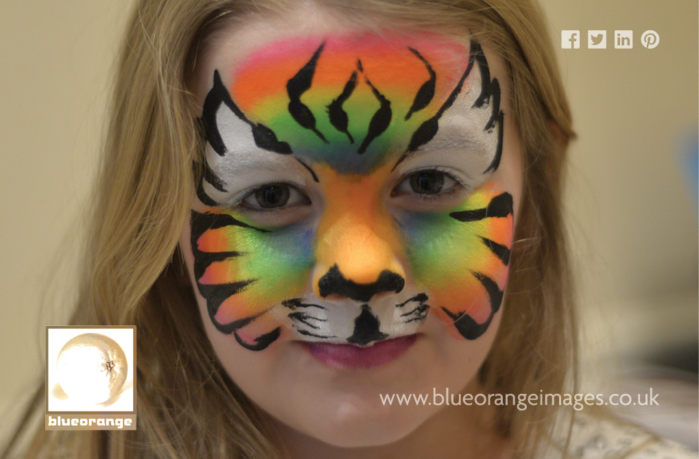 Blue Orange Images face painting: rainbow tiger face design